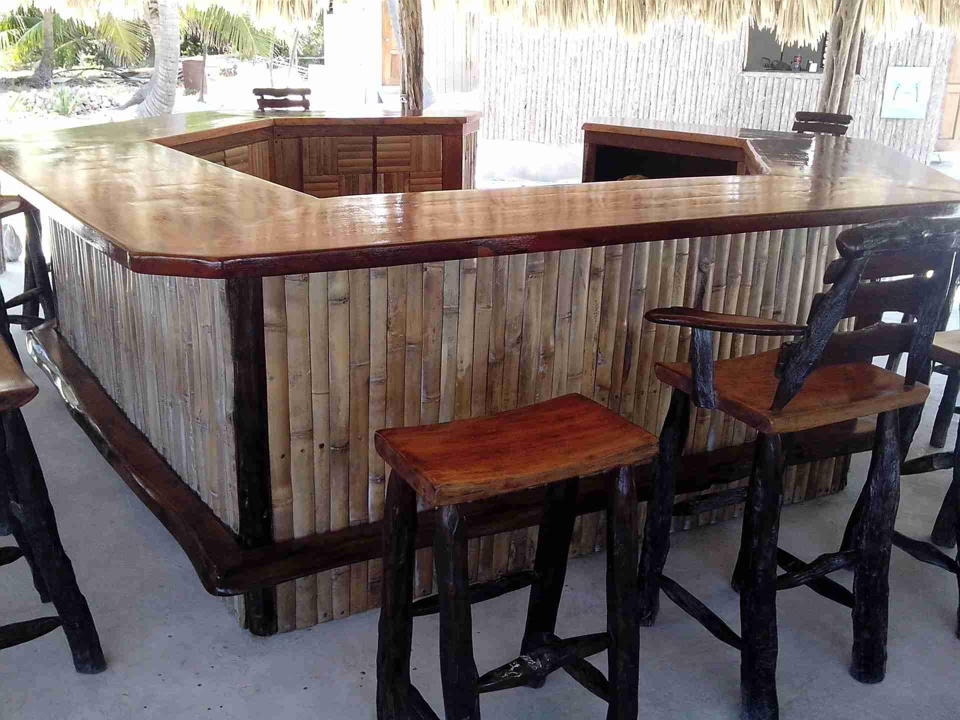 L-shaped bar with a bamboo front, a polished wood top and hardwood bar stools