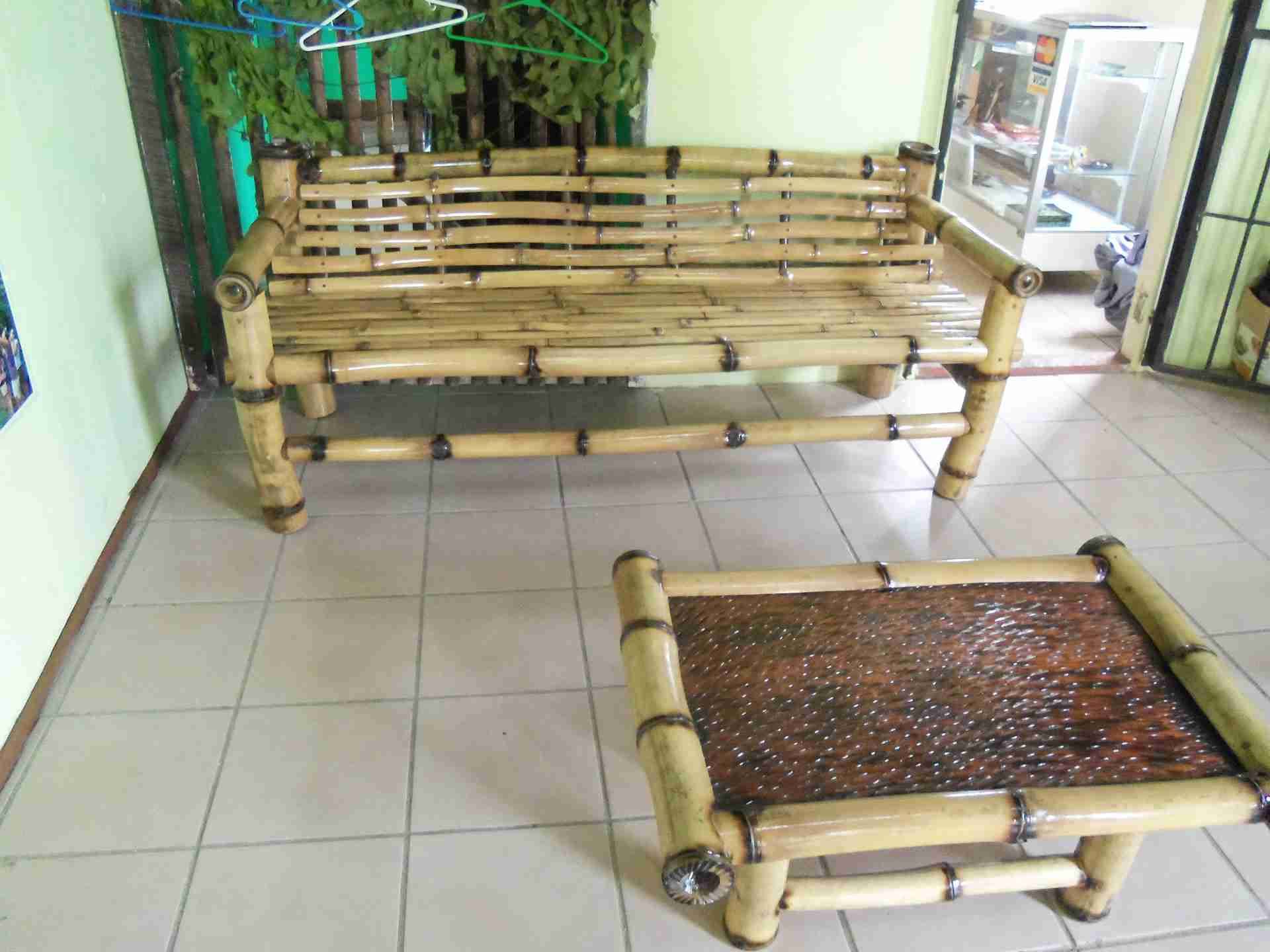 Bamboo bench and a low bamboo table with a woven top on a tiled floor