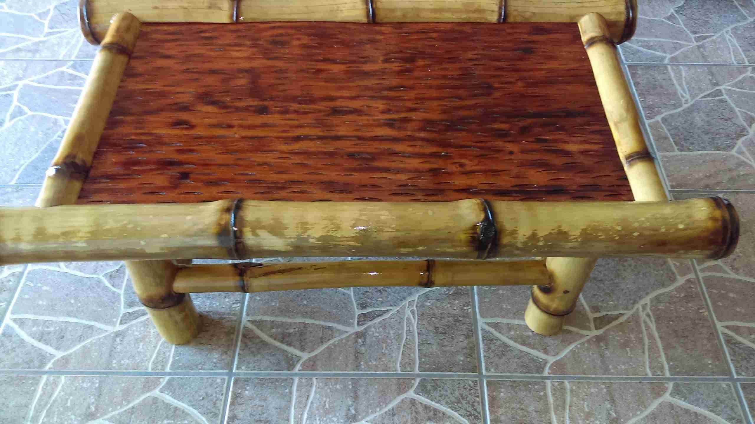 Bamboo coffee table with a dark burnt-finish top on a tile floor