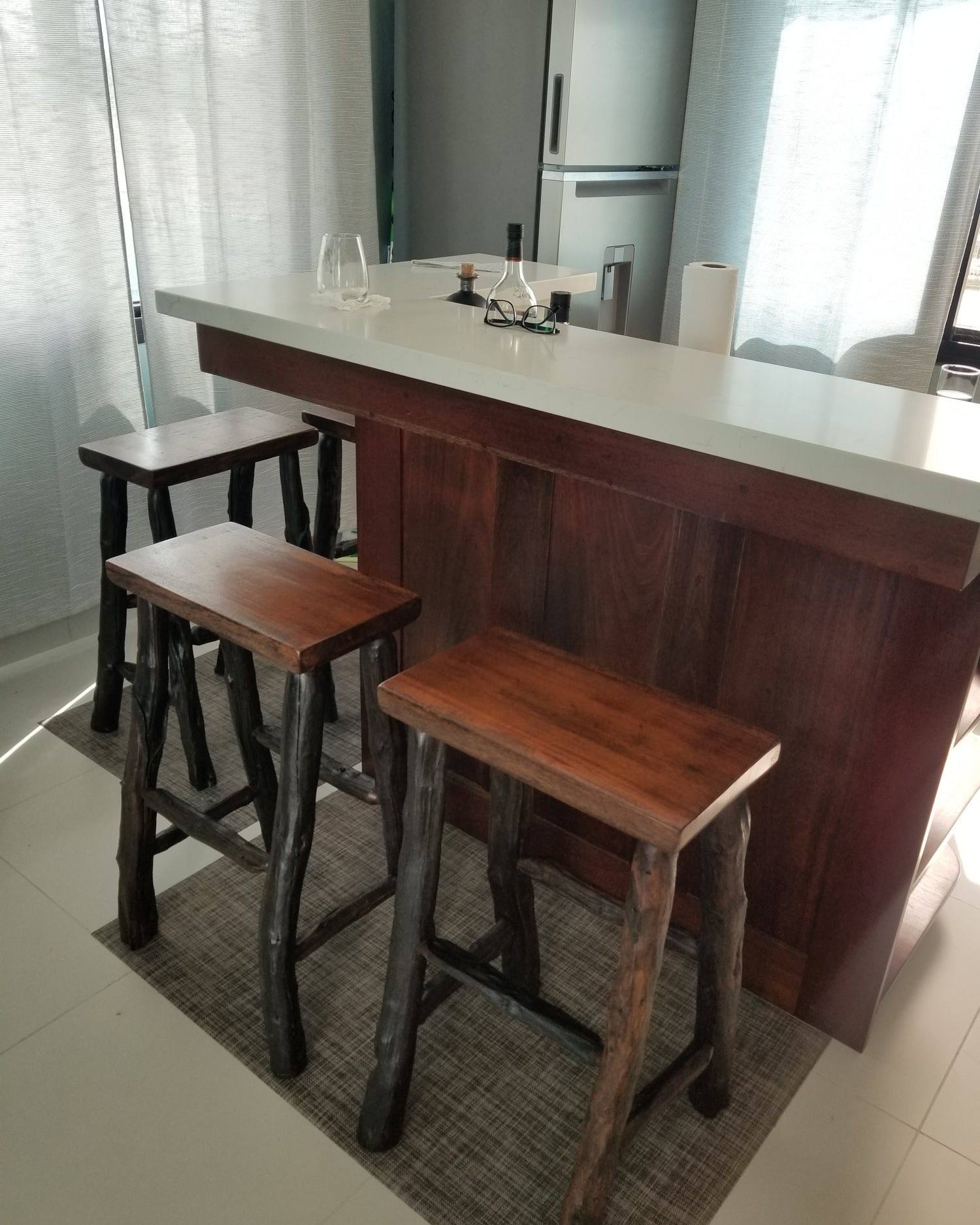 Hardwood bar stools with branch legs at a kitchen island