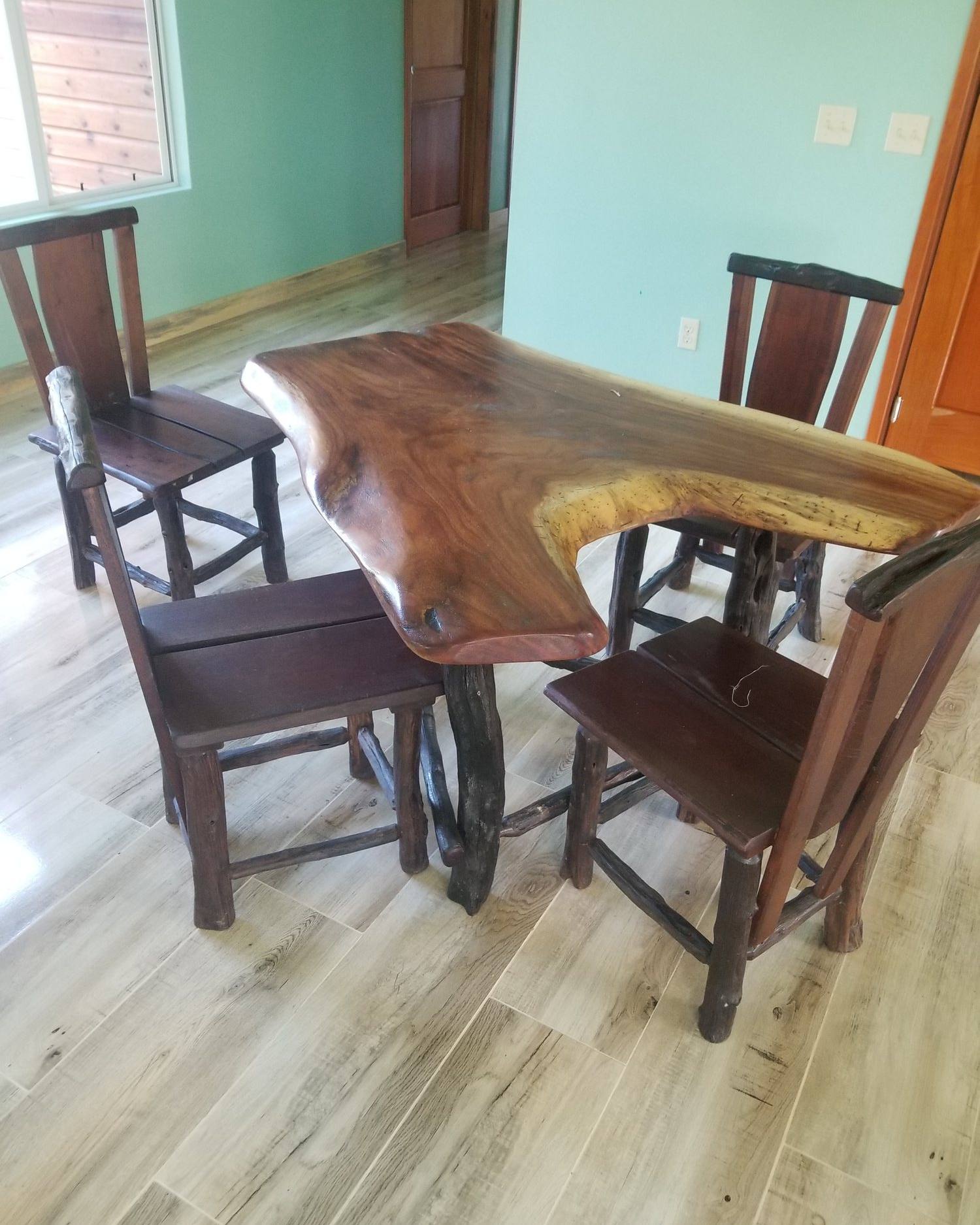 Live-edge hardwood dining table with four high-back hardwood chairs