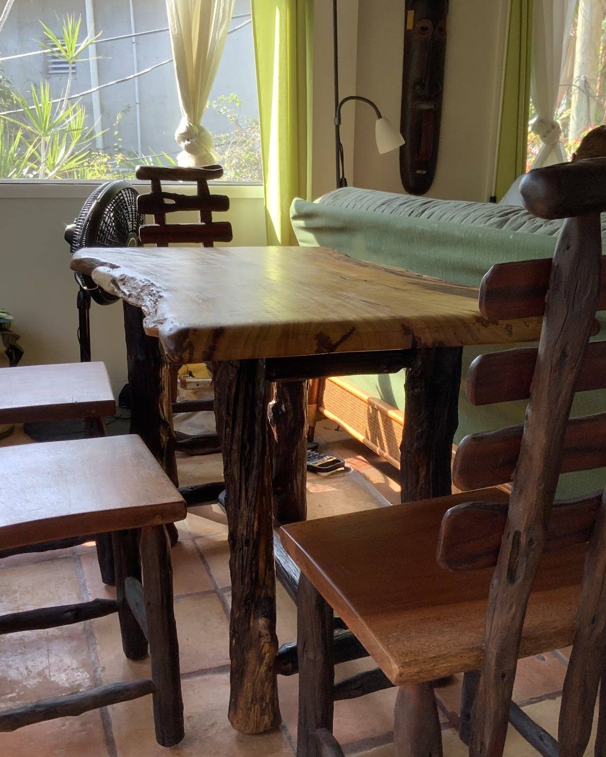 Live-edge logwood dining table and chairs in a bright dining room