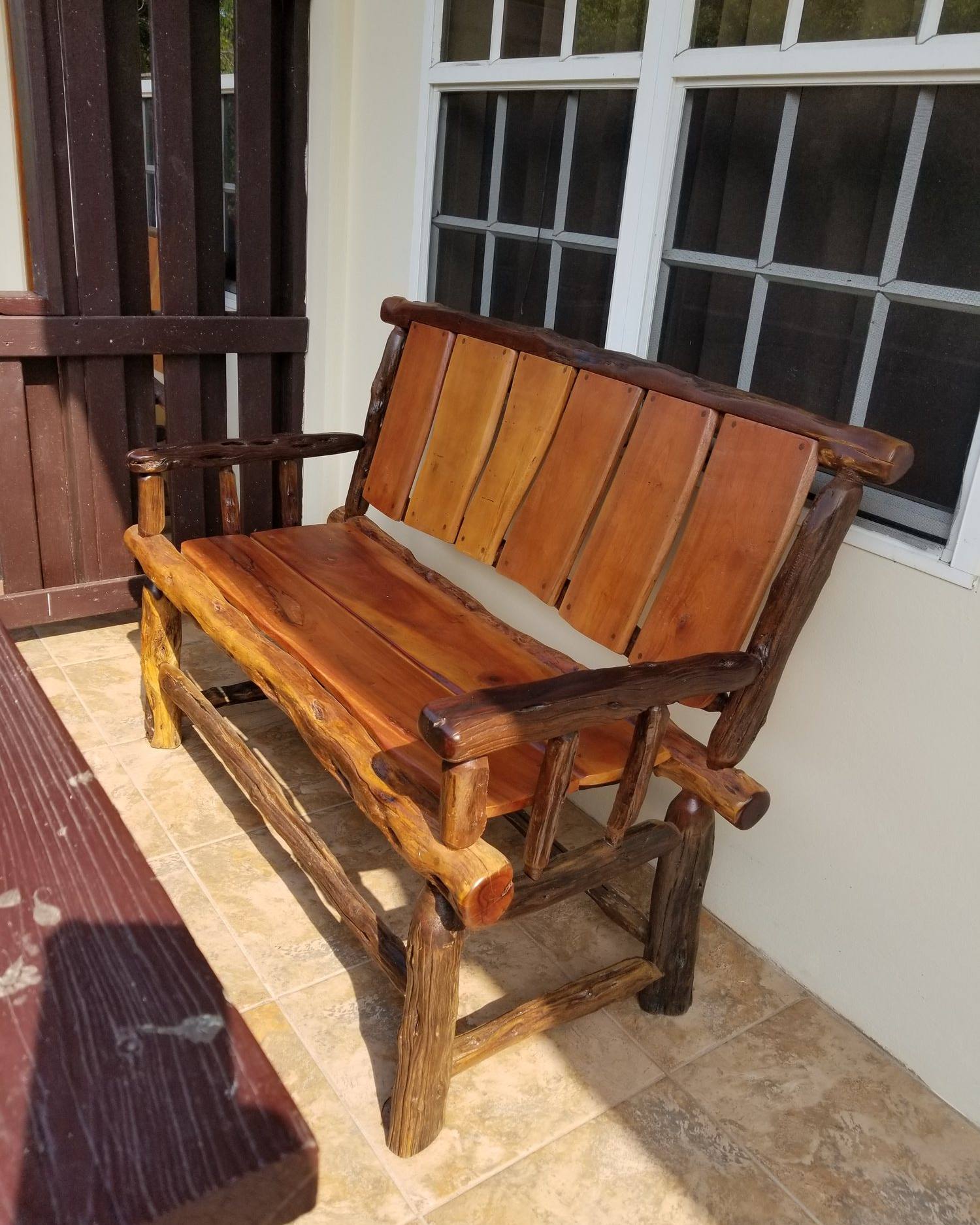 Bench with mahogany slat seat and back on a dark logwood frame