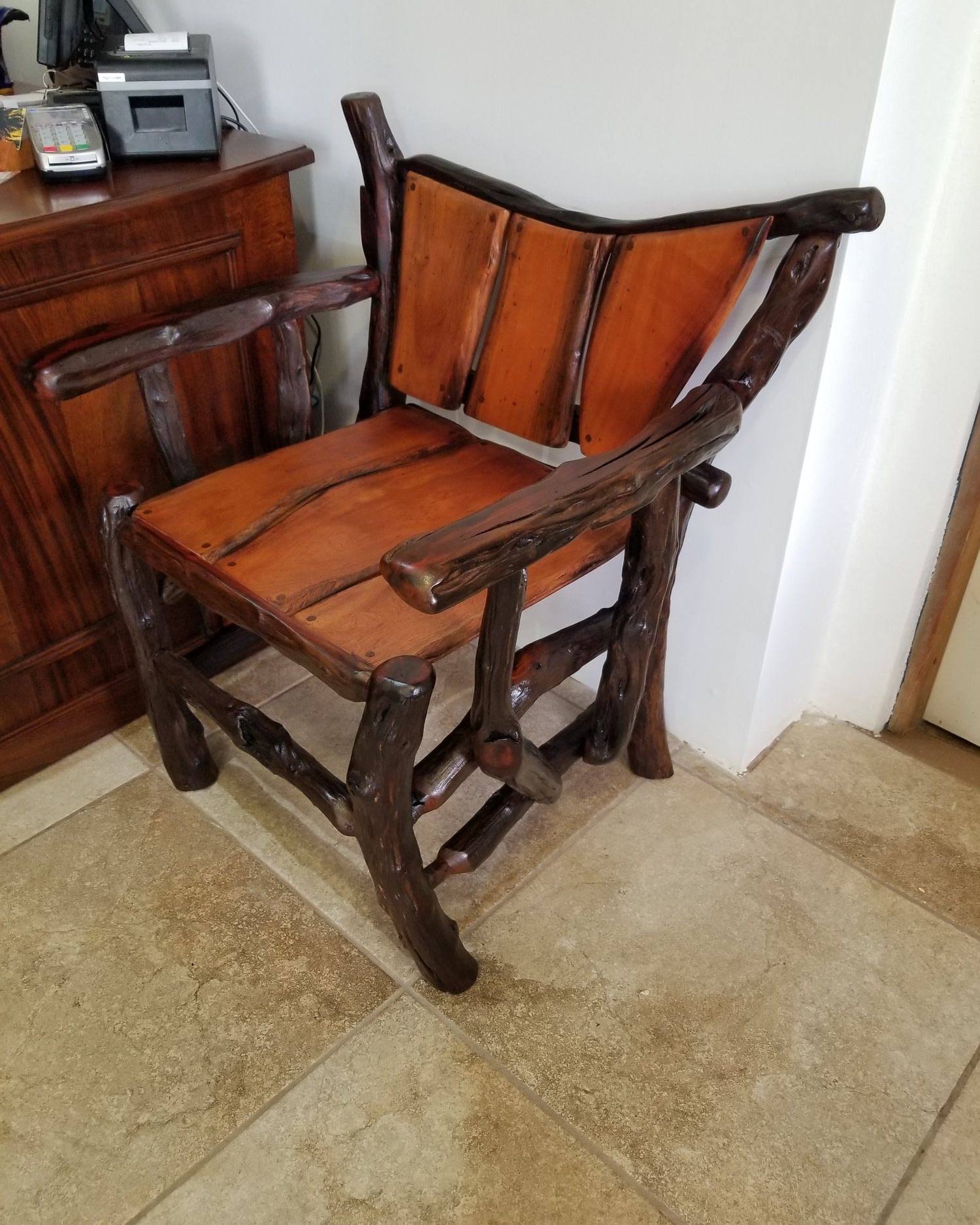 Lounge chair with a curved hardwood back and wide arms