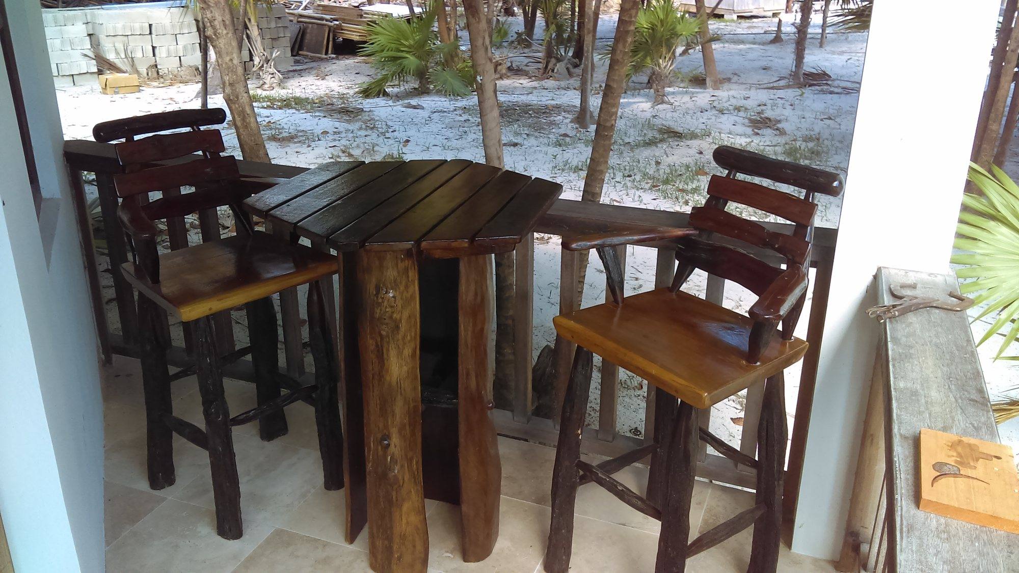 Hardwood bar stools and tables at an open-air resort bar