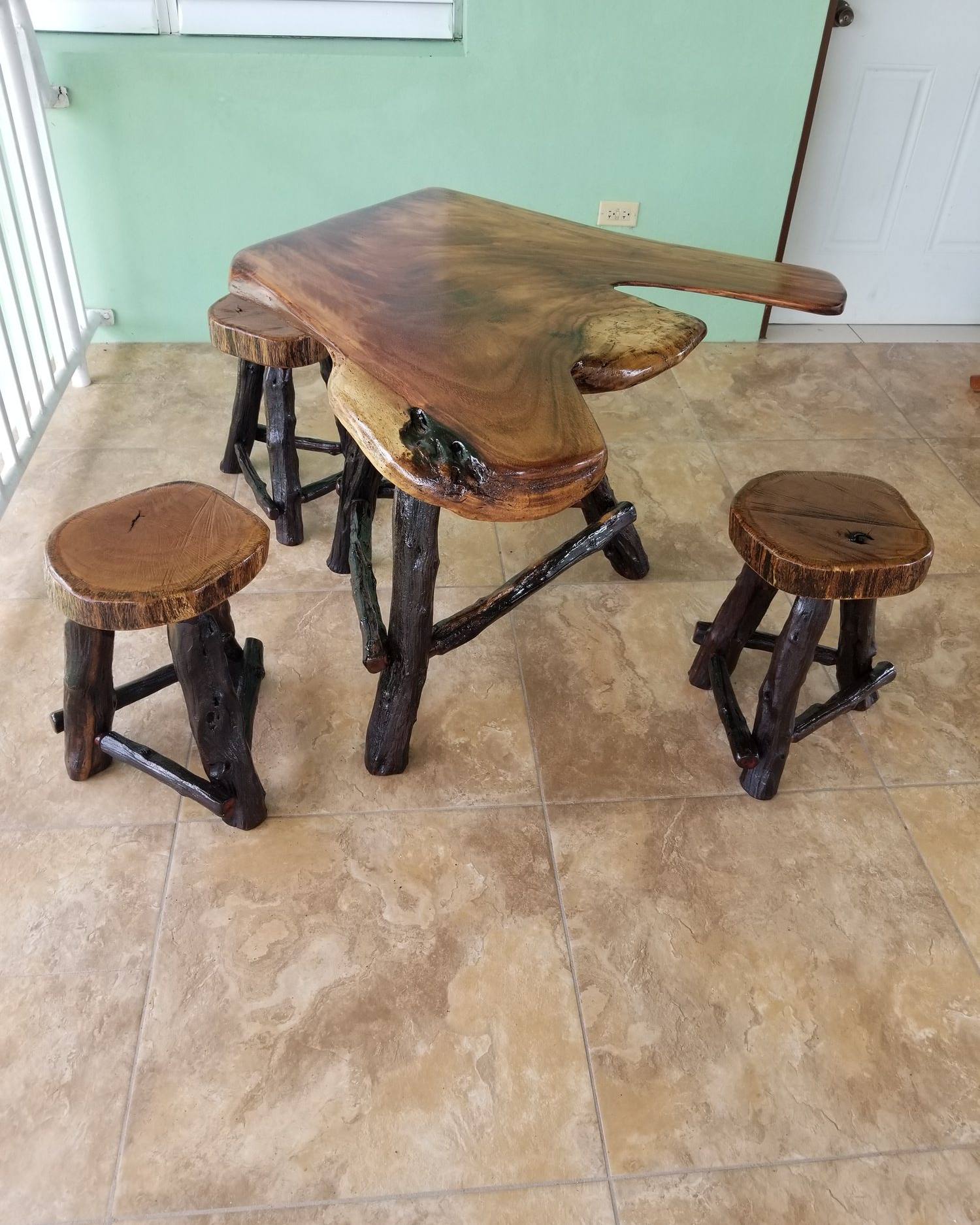 Live-edge bar-height table on a branch base with round stump stools
