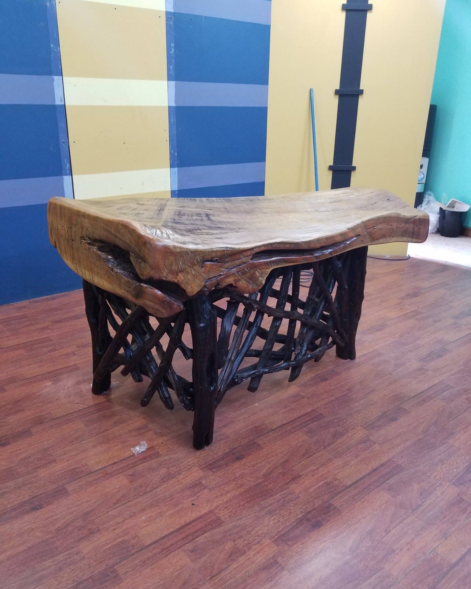 Live-edge slab coffee table on twisting branch legs
