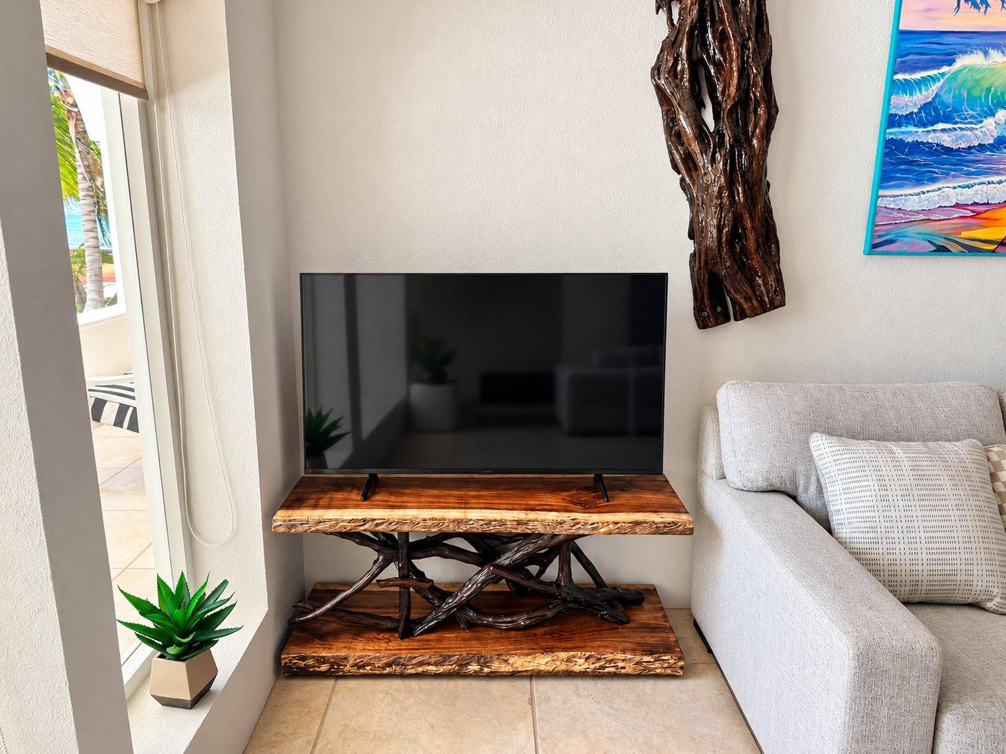 Low live-edge media console under a wall-mounted television